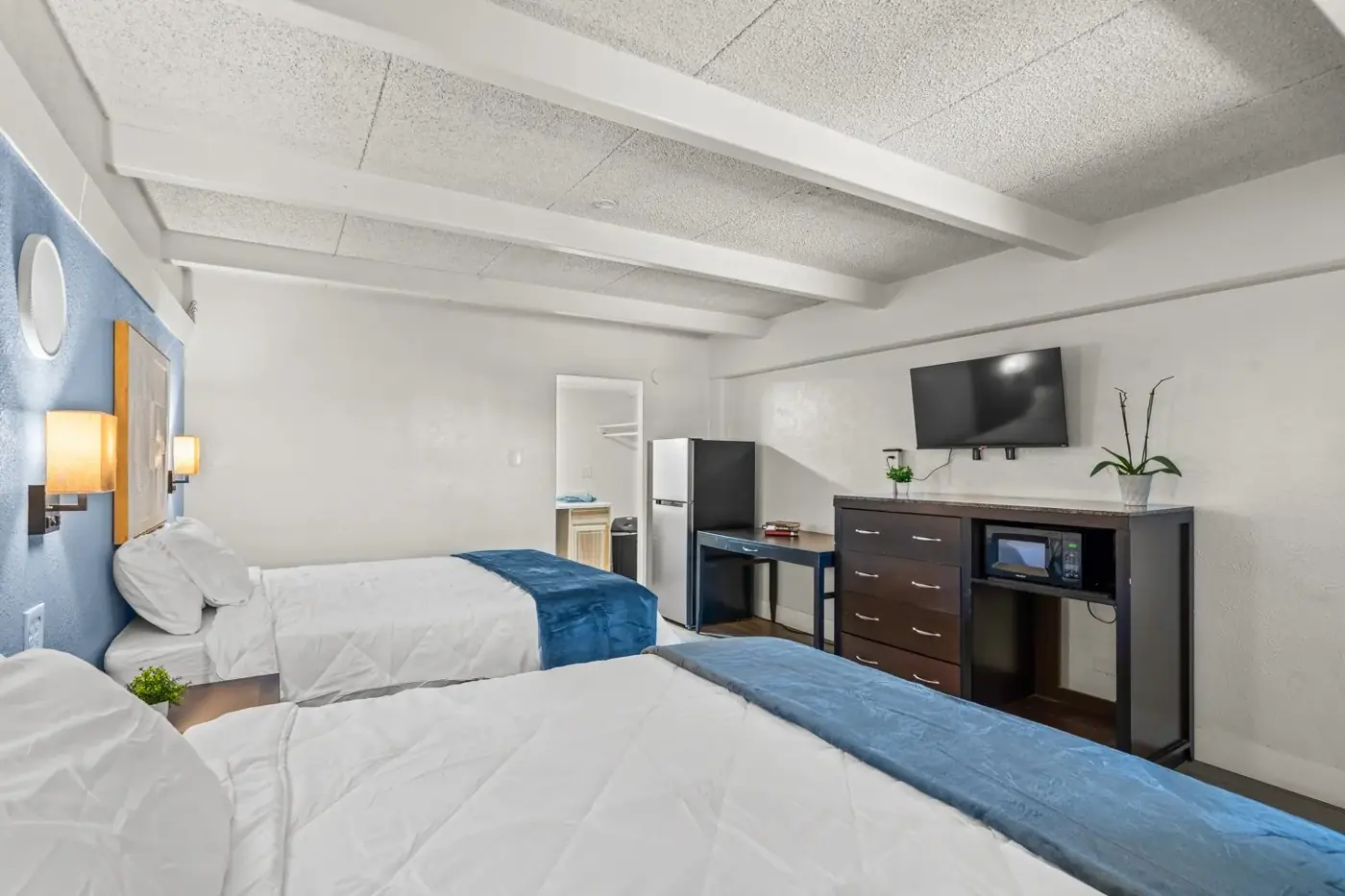 Double queen room with dresser and TV